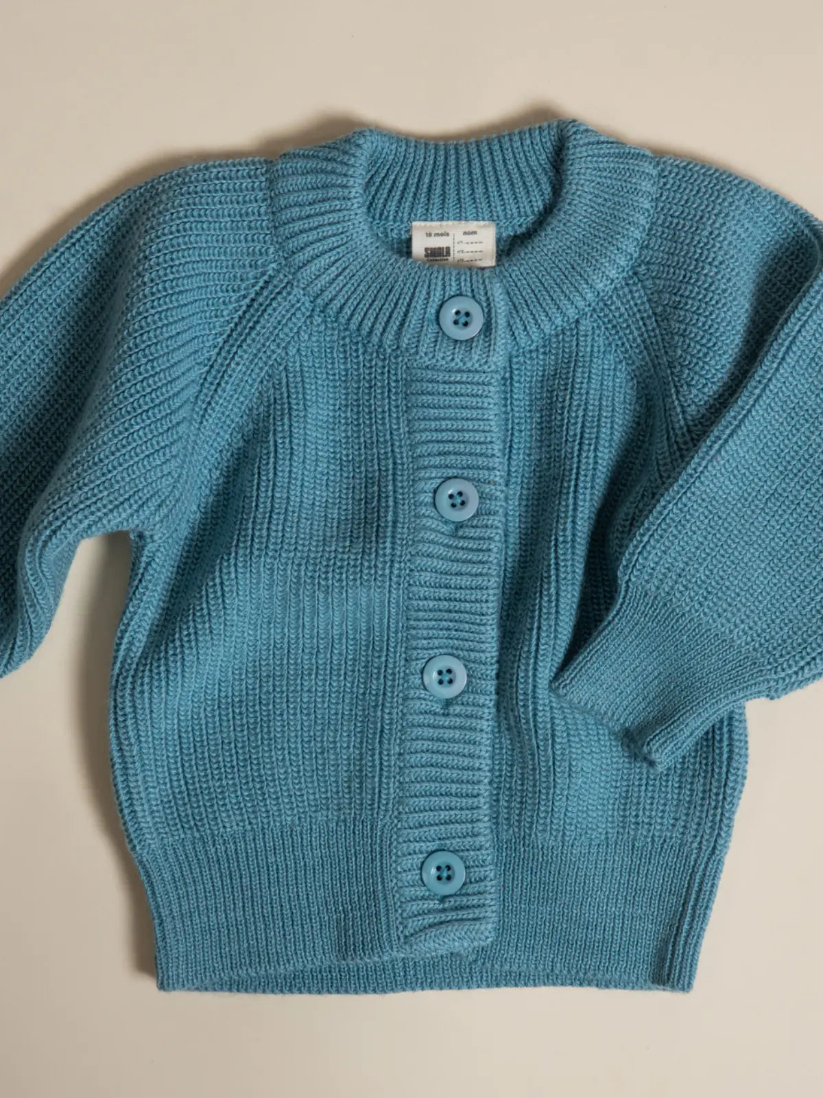 Le gilet bébé 100% laine Bleu vintage