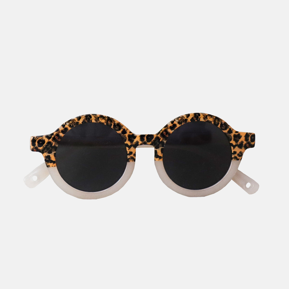 Paire de lunettes de soleil bébé catégorie 4, monture en TPEE effet transparent couleur beige avec motif léopard sur le haut 